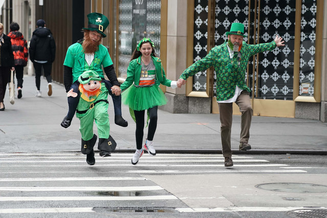 Hop skip and a jump on 5 th ave., near 54st. NYC on March 17, 2020. Paul Coyle (R) with daughter Niamh Coyle, age 11, and (left)  Darrel Edwards. All came over for the parade from Manchester and decided to walk along route today. St Patrick's parade cancelled today due to corona virus. (Photo by Robert Miller/The New York Post)