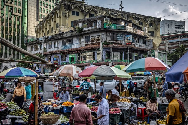 Sellers wait for costumers at their stalls at a wholesale market in Dhaka on August 14, 2024, days after a student-led uprising that ended the 15-year rule of Sheikh Hasina. (Photo by Luis Tato/AFP Photo)