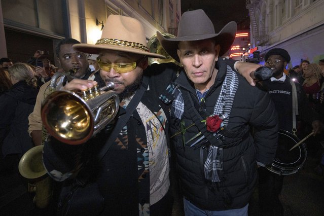 Amir “Tubad” Gray, left, leads Tubad and the Kings of NOLA Brass Band and artist Roberto Marquez, right, in New Orleans, Saturday, January 4, 2025, as they memorialize the victims of the New Year's Day deadly truck attack and shooting. Marquez organized the parade and vigil and designed a memorial for the victims on Bourbon Street. (Photo by Matthew Hinton/AP Photo)
