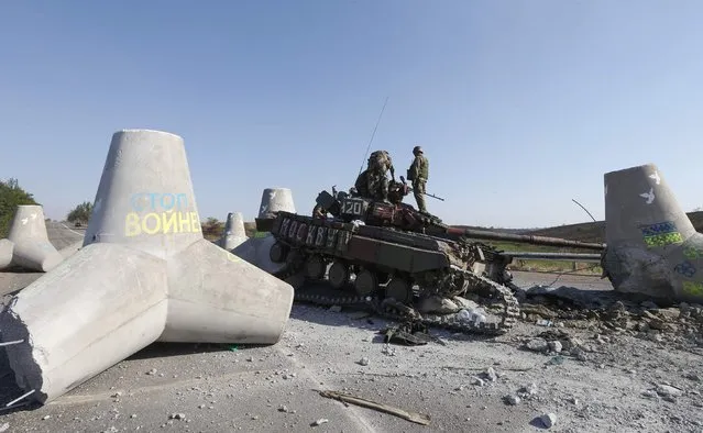 Ukrainian soldiers inspect damaged tank on the outskirts of the southern coastal town of Mariupol September 6, 2014. Russian President Vladimir Putin and Ukraine's President Petro Poroshenko agreed on Saturday in a telephone call that a ceasefire in eastern Ukraine was generally holding but said further steps were needed to make it more durable. (Photo by Vasily Fedosenko/Reuters)