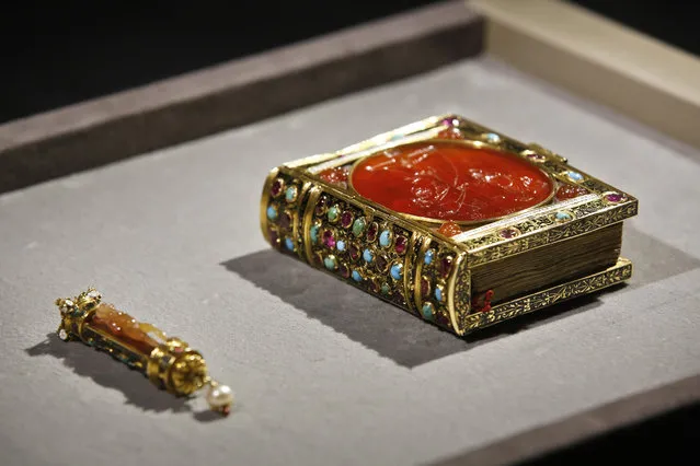 A prayer book (1532) that belongs to a private British collector, and which was once owned by the court of French King Francois I (1494-1547) is displayed during a crowdfunding campaign, at the Louvre museum, in Paris, Tuesday, October 24, 2017. The Louvre museum hopes to bing back to France one of the French Renaissance's most prized decorative art pieces. (Photo by Thibault Camus/AP Photo)