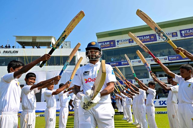 Sri Lanka's Dimuth Karunaratne (C) receives a farewell after declaring his retirement from international cricket at the start of the first day of second test cricket match against Australia at the Galle International Cricket Stadium in Galle on February 6, 2025. (Photo by Ishara S. Kodikara/AFP Photo)