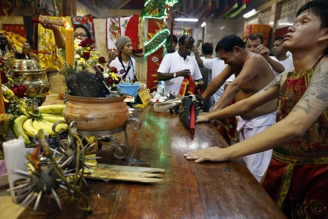 Devotees of the Chinese Bang Neow Shrine work themselves into trance before a procession celebrating the annual vegetarian festival in Phuket September 29, 2014. (Photo by Damir Sagolj/Reuters)