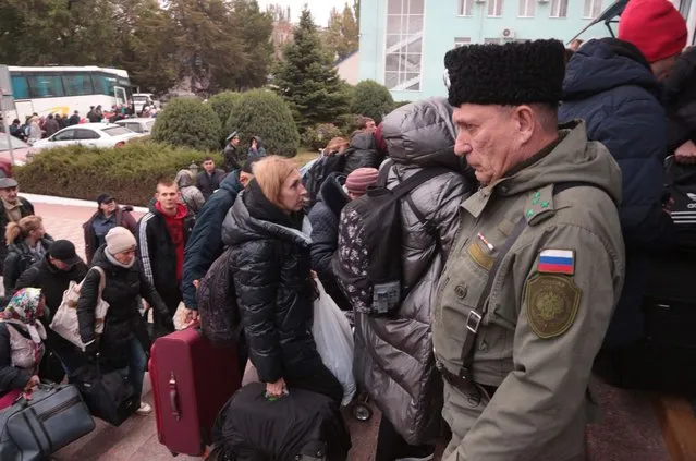 People arrived from Kherson wait for further evacuation into the depths of Russia at the Dzhankoi's railway station in Crimea on October 21, 2022. The Moscow-installed authorities of the southern Ukrainian Kherson region said on October 20, 2022 that around 15,000 people have been pulled from the territory that Russia claims to have annexed in the face of a Ukrainian advance. (Photo by AFP Photo/Stringer)
