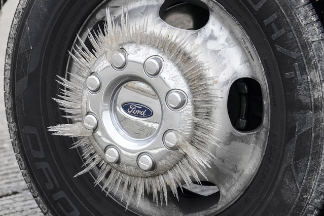Ice forms on a truck's wheel as temperatures dropped below freezing, Monday, January 15, 2024, in Conroe, Texas. (Photo by Brett Coomer/Houston Chronicle via AP Photo)