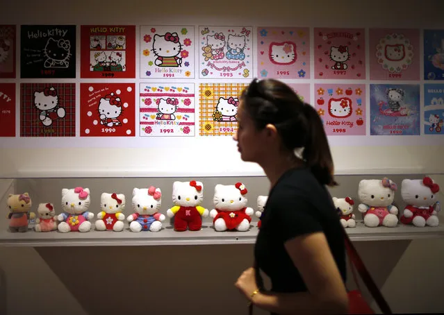 A woman walks past a display case at the “Hello! Exploring the Supercute World of Hello Kitty” museum exhibit in honor of Hello Kitty's 40th anniversary, at the Japanese American National Museum in Los Angeles, California October 10, 2014. (Photo by Lucy Nicholson/Reuters)