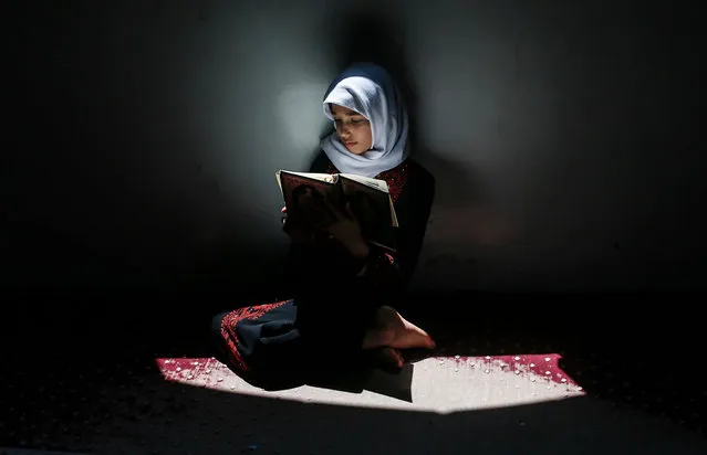 A Palestinian girl attends a Koran memorization class while respecting social distancing due to the COVID-19 pandemic, at a mosque in Gaza City, on June 29, 2020. (Photo by Mahmud Hams/AFP Photo)