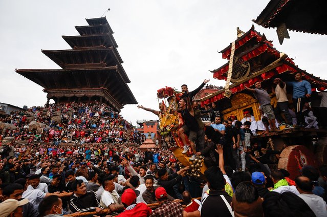 Devotees pull the chariot of God Bhairab through the city center during the Biska festival in Bhaktapur, Nepal on April 10, 2025. (Photo by Navesh Chitrakar/Reuters)