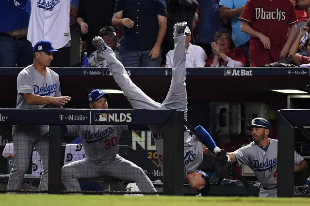 Cody Bellinger #35 of the Los Angeles Dodgers tumbles into the dugout after catching a foul ball during the fifth inning of the National League Divisional Series game three against the Arizona Diamondbacks at Chase Field on October 9, 2017 in Phoenix, Arizona. (Photo by Norm Hall/Getty Images)