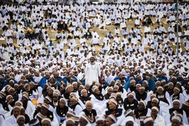 Thousands of members of the Nazareth Baptist Church, popularly known as the Shembe Church attend the annual prayer and reconciliation ceremony addressed by one of the largest African church leader's Prophet Mduduzi “uNyazilwezulu” Shembe at the Enyokeni Zulu Royal Palace some 400 kilometres north of Durban, on November 26, 2022. (Photo by Rajesh Jantilal/AFP Photo)