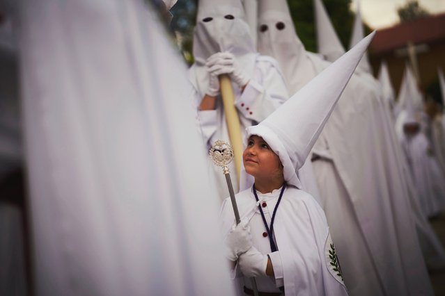 Penitents from “La Paz” brotherhood take part in a procession in Seville, Spain, Sunday, April 13, 2025. (Photo by Emilio Morenatti/AP Photo)
