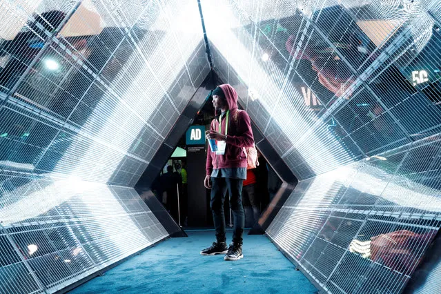 Jordan Jtakin walks though a 5G wireless broadband technology display in the Intel booth during the 2018 CES in Las Vegas, Nevada, U.S. January 10, 2018. (Photo by Steve Marcus/Reuters)