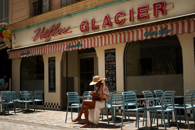 A woman sits at the terrace of a closed ice-cream shop after an electricity outage during the 78th Cannes film festival in Cannes, France on May 24, 2025. French authorities launched an investigation into a power blackout blamed on sabotage that affected at least 45,000 people, just a day after a similar outage disrupted the final day of the Cannes film festival. (Photo by Stéphane Mahé/Reuters)