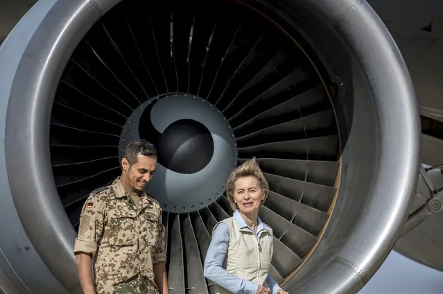 German defense minister  Ursula von der Leyen,right, is accompanied by an unidentified German soldier after her arrival to Azraq air base in northern Jordan Saturday, Jan. 13, 2018. The Germany's defense minister is visiting a Jordanian air base where German troops have been stationed since October as part of an international military campaign against Islamic State extremists. A group of German parliamentarians accompanied Ursula von der Leyen on Saturday during her tour of the Azraq base in northern Jordan. (Michael Kappeler/Pool via AP)