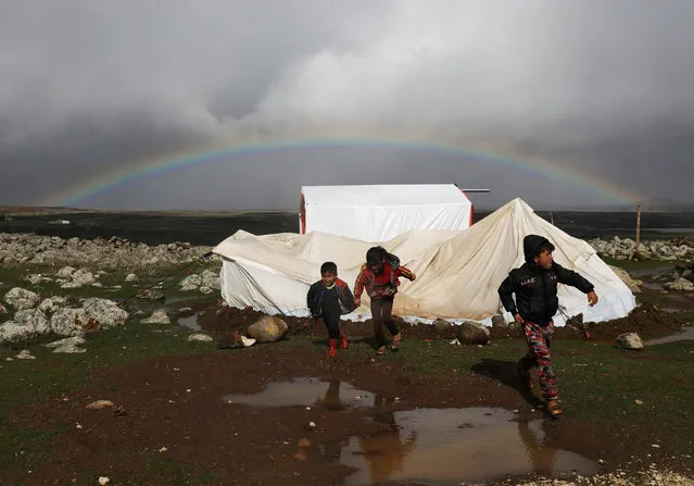 A rainbow is seen over Quneitra as internally displaced children run at a refugee camp in Quneitra, Syria, January 19, 2018. (Photo by Alaa Al-Faqir/Reuters)