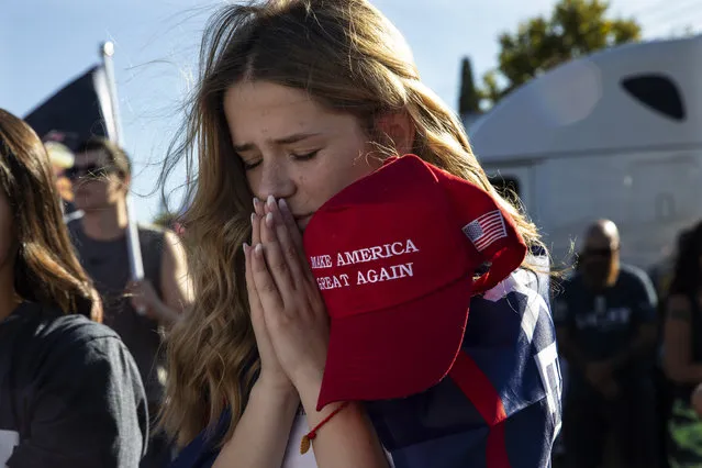 Liza Durasenko, 16, from Oregon City, Ore., prays during a rally in support of President Donald Trump on Saturday, August 29, 2020, in Clackamas, Ore. (Photo by Paula Bronstein/AP Photo)