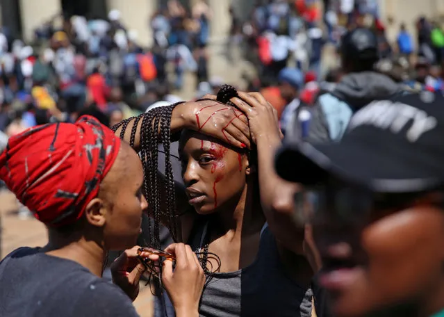 An injured student is attended to by her schoolmates after clashes with security at University of the Witwatersrand on Tuesday, as countrywide protests demanding free tertiary education entered a third week, Johannesburg, South Africa, September 20,2016. (Photo by Siphiwe Sibeko/Reuters)