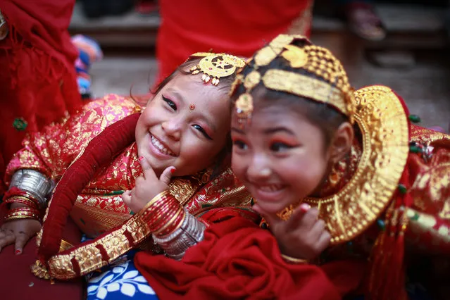 Young girls pose for camera while participating in Ihi ceremony held at Chandeswari Temple in Bhaktapur, Nepal on November 27, 2022. During the ceremony, the young girls aged 5 to 9 years of Newar community are married to an ever-fresh fruit “Bel”, which is considered to be an incarnation of lord Vishnu. Similarly, Bahra (or Gufa) is another ceremony where the young girls are symbolically married to Sun God. It is believed that this ritual prevents girls from the stigma of widowhood as even if their husbands pass away later in life, they would still be married to the gods Vishnu and Sun. (Photo by Amit Machamasi/ZUMA Press Wire/Rex Features/Shutterstock)