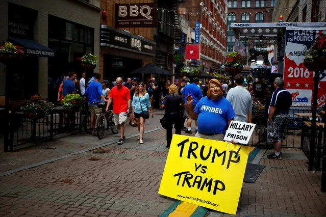 A protestor stands across from Quicken Loans Arena as setup continues in advance of the Republican National Convention in Cleveland, Ohio, U.S., July 16, 2016. (Photo by Aaron P. Bernstein/Reuters)