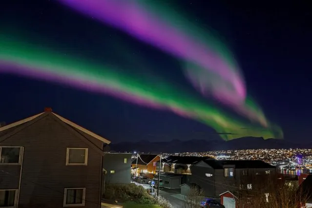 Northern lights are seen over Tromsoe, Norway on November 2, 2022. (Photo by Rune Stoltz Bertinussen/NTB via AFP Photo)