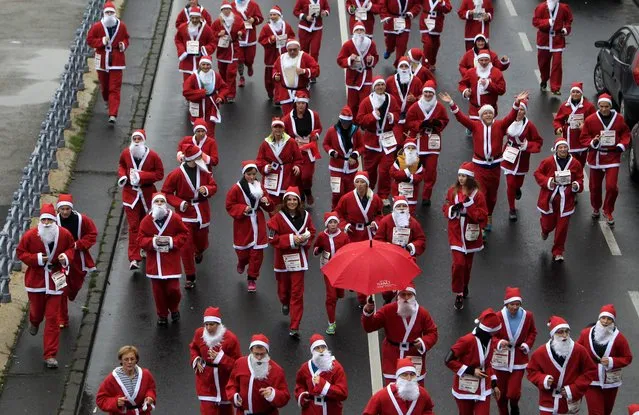 Runners dressed in Santa Claus costumes take part in the “Santa Claus Run” in Budapest, December 6, 2014. Around 3,000 runners took part this year. (Photo by Bernadett Szabo/Reuters)