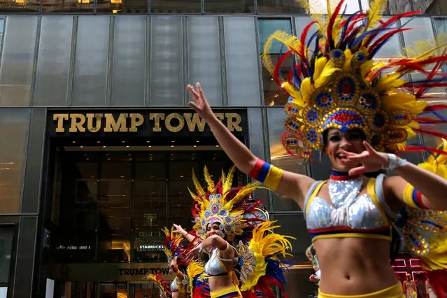Dancers in costume pass Republican presidential nominee Donald Trump's Trump Tower while participating in the 52nd annual Hispanic Day Parade in Manhattan, New York, U.S., October 9, 2016. (Photo by Andrew Kelly/Reuters)
