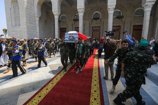 Yemeni honor guard carry the coffins of Prime Minister of Yemen's Houthi-led government Ahmed Ghaleb Al-Rahwi (front) and other officials killed in an Israeli strike days earlier, during a funeral procession in Sanaa on September 1, 2025. Yemen's Huthi rebels held a funeral on September 1 for their prime minister, nine ministers, and two cabinet officials, killed in an Israeli air strike on August 28 as they attended a government meeting in the Sanaa area. (Photo by Mohammed Huwais/AFP Photo)