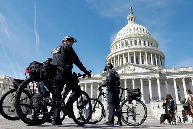U.S. Capitol Police officers patrol on bicycles as security officials prepare for the possible indictment of former U.S. President Donald Trump over an alleged hush-money payment to p*rn star Stormy Daniels during his 2016 campaign, at the U.S. Capitol in Washington, U.S. March 21, 2023. (Photo by Jonathan Ernst/Reuters)