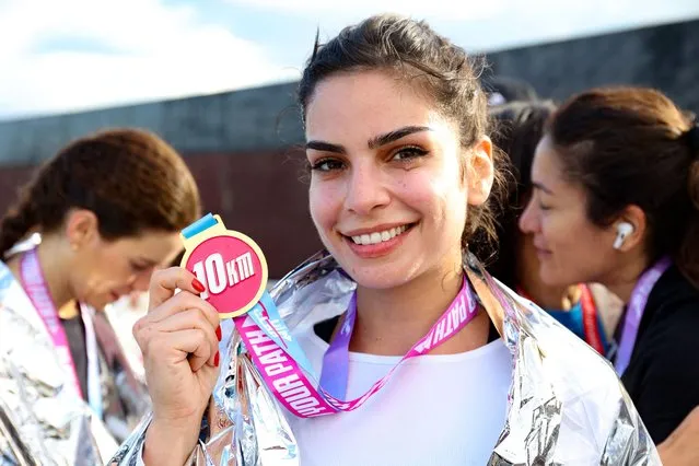 Lebanese actress Rita Hayek shows her 10km medal after participating in the 9th edition of the Women's Race in Beirut on March 19, 2023, under the slogan “Draw Your Path”. (Photo by Anwar Amro/AFP Photo)