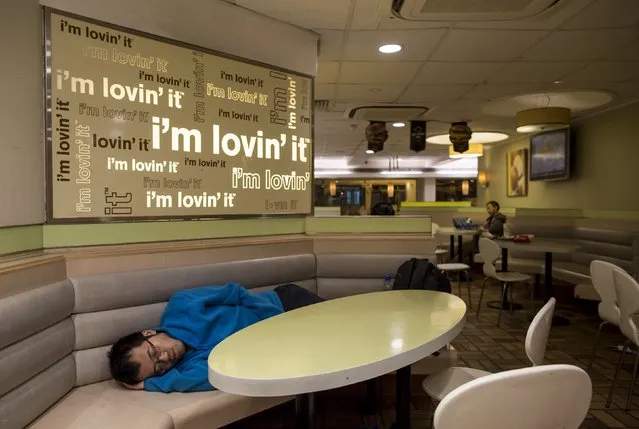 A man sleeps at a 24-hour McDonald's restaurant in Hong Kong, China November 11, 2015. (Photo by Tyrone Siu/Reuters)