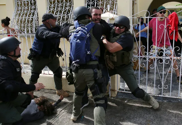 Police detain a man during a May Day protest against austerity measures, in San Juan, Puerto Rico May 1, 2018. (Photo by Alvin Baez/Reuters)