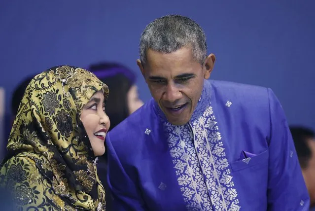 U.S. President Barack Obama (R) talks with Queen Saleha, the wife of Brunei's Sultan Hassanal Bolkiah, at the gala dinner of the 27th Association of Southeast Asian Nations (ASEAN) summit in Kuala Lumpur, Malaysia, November 21, 2015. (Photo by Olivia Harris/Reuters)