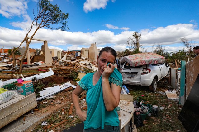 Ligia Daiana Back cries over the debris of her house destroyed by a tornado with winds of up to 250 km/h that hit the city of Rio Bonito do Iguaçu, in Paraná state, Brazil, on November 8, 2025. A tornado killed at least six people and injured around 750 as it destroyed most of a town in southern Brazil, authorities said Saturday. The twister on Friday evening flipped cars like toys and wrecked buildings in Rio Bonito do Iguacu, a town of 14,000 people in Parana state, officials said. (Photo by Daniel Castellano/AFP Photo)