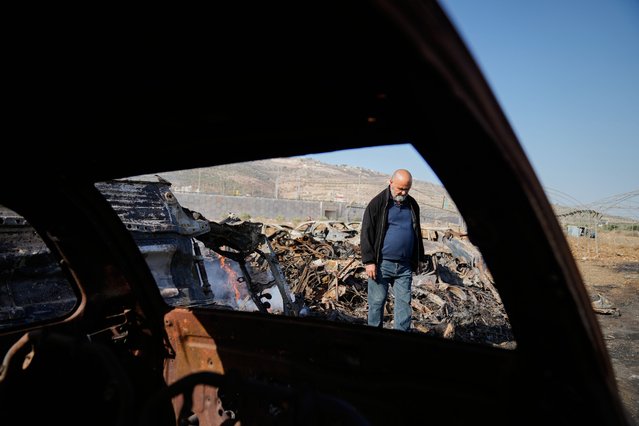 Mohammad Dalal looks at scorched cars in his scrapyard that was set ablaze the night before by who local residents alleged were Israeli settlers in the town of Huwara near the West Bank city of Nablus, Friday, November 21, 2025. (Photo by Nasser Nasser/AP Photo)
