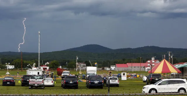 A storm moves in Tuesday August 4, 2015, as investigators inspect the site of a circus tent that collapsed Monday during a show by the Walker Brothers International Circus at the Lancaster Fair grounds in Lancaster, N.H.  (Photo by Jim Cole/AP Photo)
