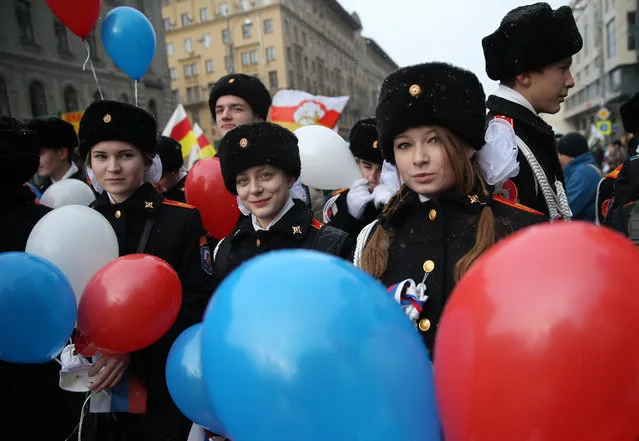 People take part in a march marking National Unity Day in Moscow, Russia, Friday, November 4, 2016. The National Unity Day is a national holiday marked on Nov. 4 and established in 2005 to replace commemorations of the Bolshevik Revolution. (Photo by Anton Novoderezhkin/TASS)