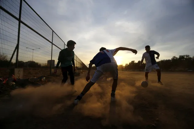 Men play soccer in Santiago, Chile, May 19, 2018. (Photo by Ivan Alvarado/Reuters)