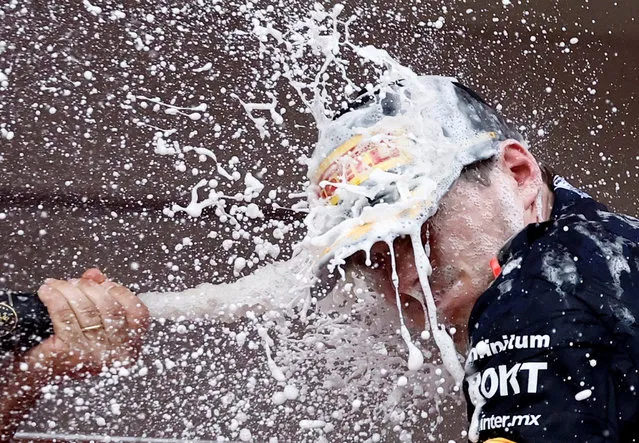 Red Bull's Max Verstappen celebrates with champagne on the podium after winning the Monaco Grand Prix in Monte Carlo on May 28, 2023. (Photo by Stephane Mahe/Reuters)