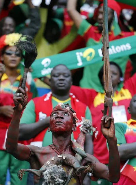 A fan of Burkina Faso listens to the national anthem before the start of the team's Group A soccer match against Equatorial Guinea at the African Cup of Nations in Bata January 21, 2015. (Photo by Amr Abdallah Dalsh/Reuters)