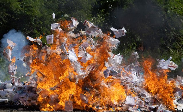 Confiscated cocaine burns in Santo Domingo, Dominican Republic, 27 November 2025. The Dominican Republic incinerated 1,450 kilograms of cocaine that were seized during three separate coastal operations this month, which were carried out in support of the US-led anti-drug campaign, Operation Southern Spear. (Photo by Orlando Barria/EPA)