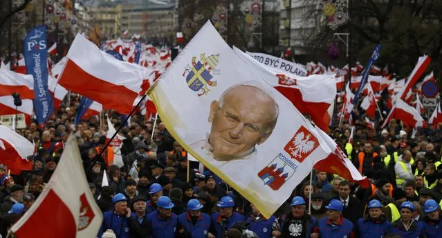 Supporters of Law and Justice party walk with a portrait of late Pope John Paul II during a pro-government demonstration in Warsaw, Poland December 13, 2015. (Photo by Kacper Pempel/Reuters)