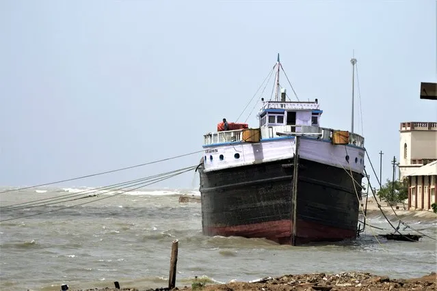 A boat is anchored at Mandvi on the Arabia Sea coast in Kutch district of Gujarat state, India, Wednesday, June 14, 2023. With Cyclone Biparjoy expected to make landfall Thursday evening, coastal regions of India and Pakistan are on high alert. (Photo by Ajit Solanki/AP Photo)