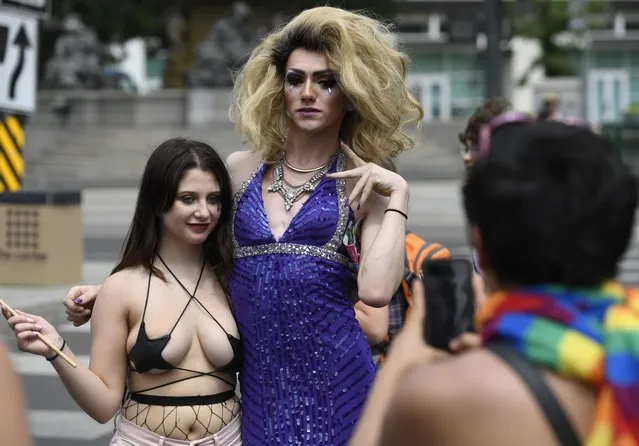 Miranda Stanfield, left, her her picture taken by a friend with Dani Jaymes from Boston, Massachusetts in Civic Center Park during Denver PrideFest on June 16, 2018. (Photo by Andy Cross/The Denver Post)