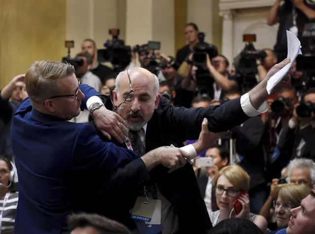 Security removes an apparent protester before a joint press conference between U.S. President Donald Trump and Russia President Vladimir Putin in the Presidential Palace in Helsinki, Finland, Monday, July 16, 2018. (Photo by Antti Aimo-Koivisto/Lehtikuva via AP Photo)