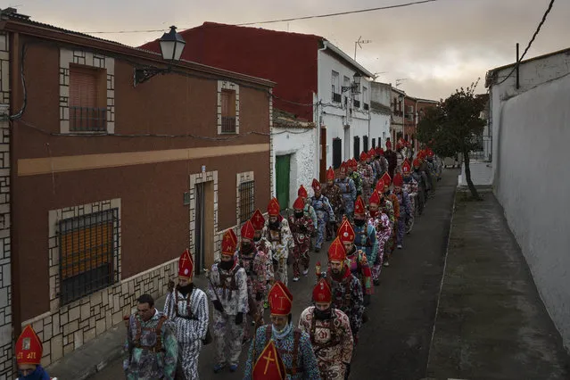 Members of the Endiablada brotherhood march during the “Endiablada” traditional festival in Almonacid Del Marquesado, Spain, Tuesday, February 3, 2015. (Photo by Daniel Ochoa de Olza/AP Photo)