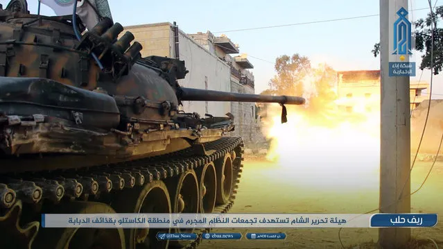 This photo provided on Monday, August 2, 2018, by the al-Qaida-affiliated Ibaa News Network, shows a tank of the al-Qaida-linked coalition known as Hay'at Tahrir al-Sham, Hay'at Tahrir al-Sham, Arabic for Levant Liberation Committee, firing at Syrian troops and pro-government gunmen in rural Aleppo, Syria. It's already being called the "mother of all battles," the last showdown between the forces of Syrian President Bashar Assad and the opposition. Idlib province, in Syria's northwest, is the only significant opposition enclave still standing and Assad has vowed to retake it. The caption in Arabic reads: “Hay'at Tahrir al-Sham targets groups of the criminal government faces in Castello area with tank shells”. (Photo by Ibaa News Network via AP Photo)