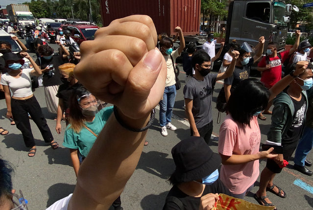 Members of the Gabriela Women's Party and their supporters raise clenched fists during a protest outside the Embassy of the United States of America  in Manila, Philippines, 05 March 2021. The group was protesting against the government's plan to renegotiate the terms of the Visiting Forces Agreement with the United States. (Photo by Francis R. Malasig/EPA/EFE)