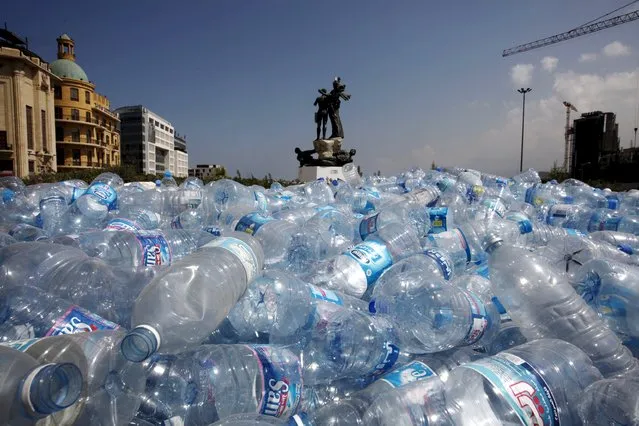 Water bottles are gathered to be recycled near a statue in Martyrs' Square in Beirut, Lebanon August 25, 2015. (Photo by Jamal Saidi/Reuters)