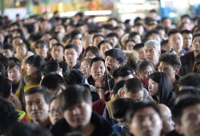 A man yawns at a railway station in Taiyuan, Shanxi province, February 16, 2015. (Photo by Jon Woo/Reuters)
