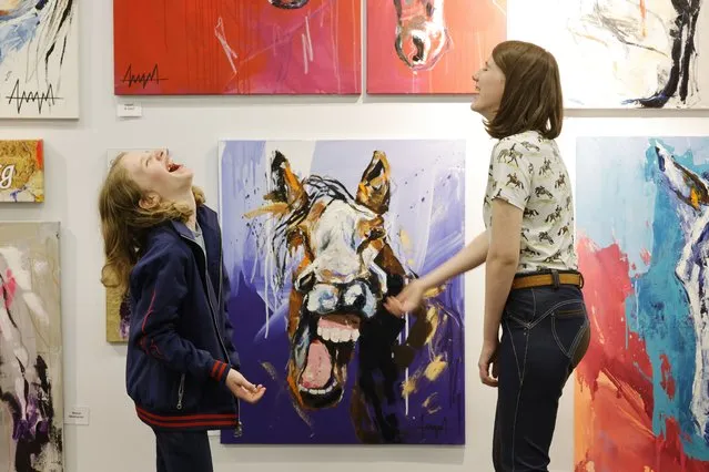 Lena Kelly and Eve O’Shea from Carlow have a laugh at the stand of Anna Schellberg, a Hamburg based artist on the first day of the RDS Dublin Horse Show 2023 on August 8, 2023. (Photo by Alan Betson/The Irish Times)